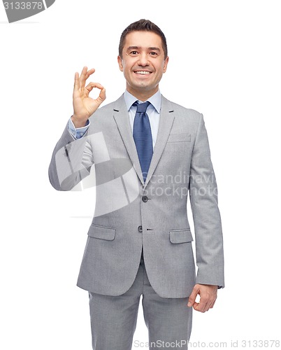 Image of happy businessman in suit showing ok hand sign