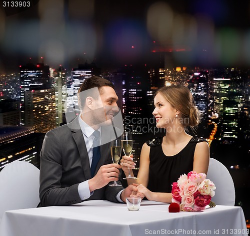 Image of couple with glasses of champagne at restaurant