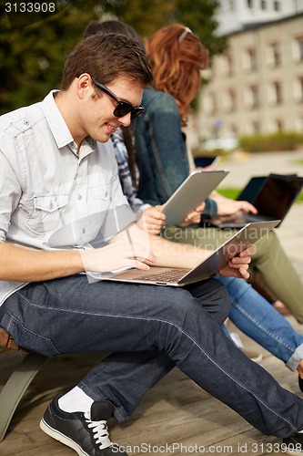 Image of students or teenagers with laptop computers