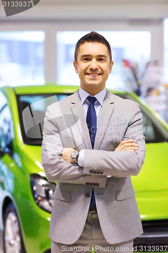 Image of happy man at auto show or car salon