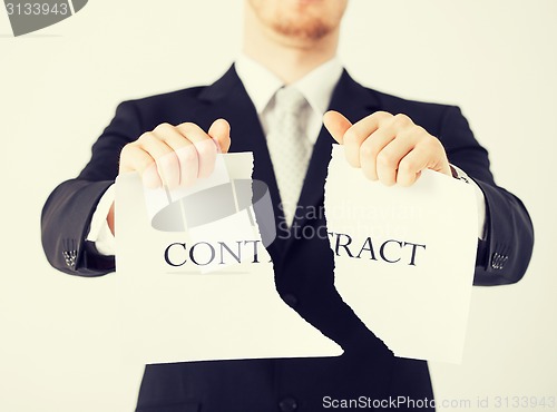 Image of man hands tearing contract paper