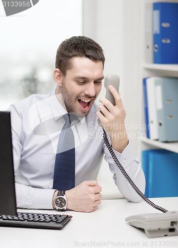 Image of screaming businessman or student with computer
