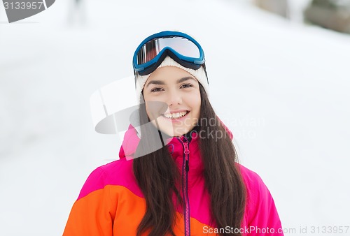 Image of happy young woman in ski goggles outdoors