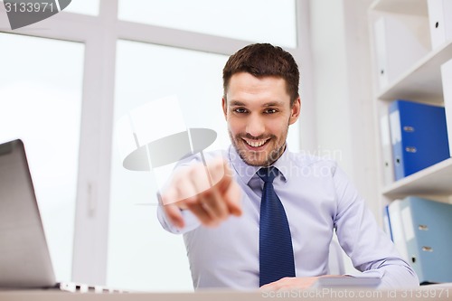 Image of happy businessman pointing on you in office