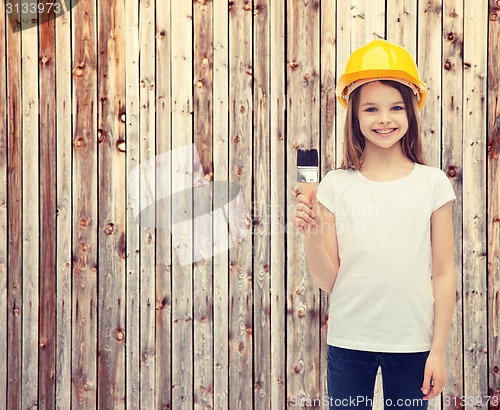 Image of smiling little girl in helmet with paint roller