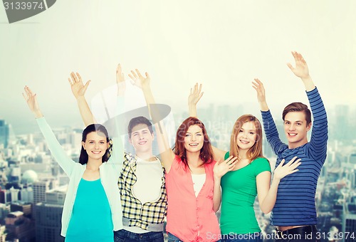 Image of group of smiling students waving hands