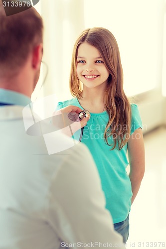 Image of male doctor with stethoscope listening to child