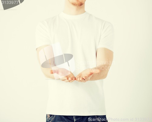 Image of mans hands showing something