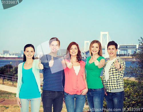 Image of group of smiling students showing thumbs up
