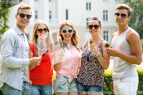 Image of group of smiling friends with ice cream outdoors