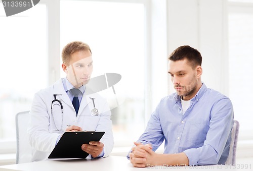 Image of doctor with clipboard and patient in hospital