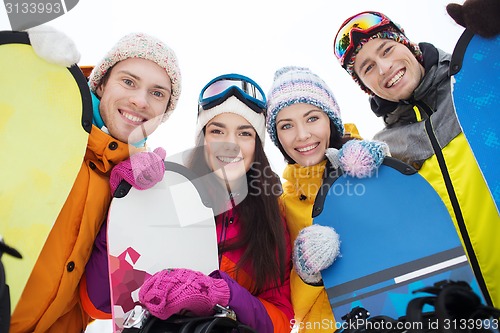 Image of happy friends with snowboards