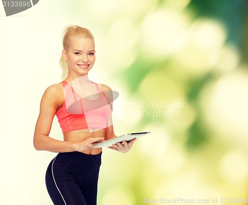 Image of smiling sporty woman with tablet pc computer