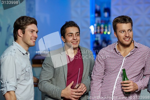 Image of group of male friends with beer in nightclub