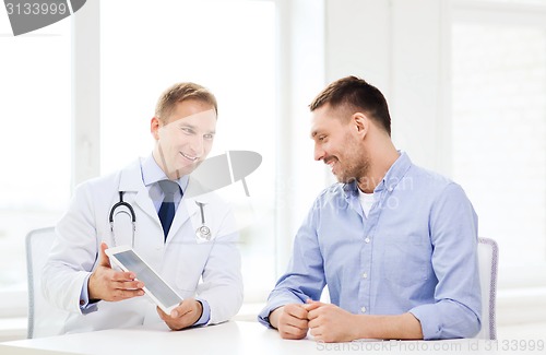 Image of doctor with tablet pc and patient in hospital