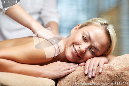 Image of close up of woman lying and having massage in spa