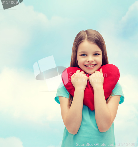 Image of smiling little girl with red heart