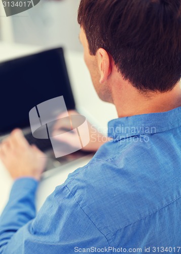 Image of close up of man with laptop computer