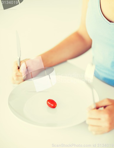 Image of woman with plate and one tomato