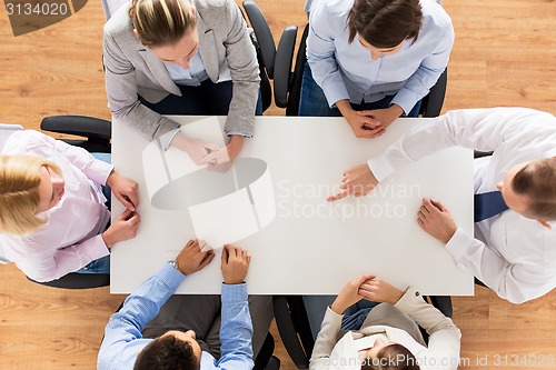 Image of close up of business team sitting at table