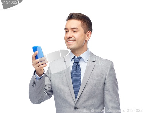 Image of happy businessman texting on smartphone