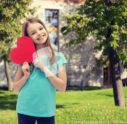 Image of smiling little girl with red heart