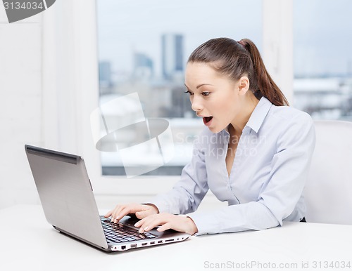 Image of surprised businesswoman with laptop