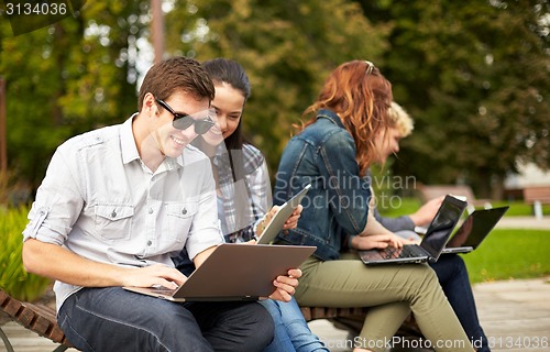 Image of students or teenagers with laptop computers