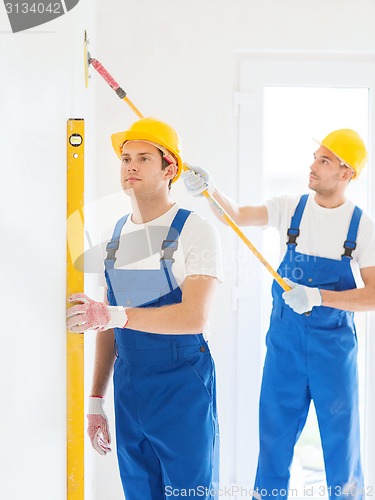 Image of group of builders with tools indoors