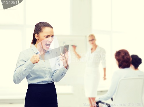 Image of screaming businesswoman with smartphone