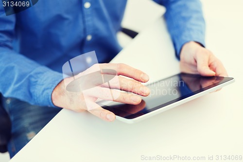 Image of close up of male hands working with tablet pc