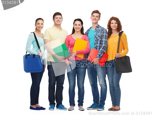 Image of group of smiling teenagers with folders and bags