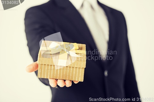 Image of man hands holding gift box