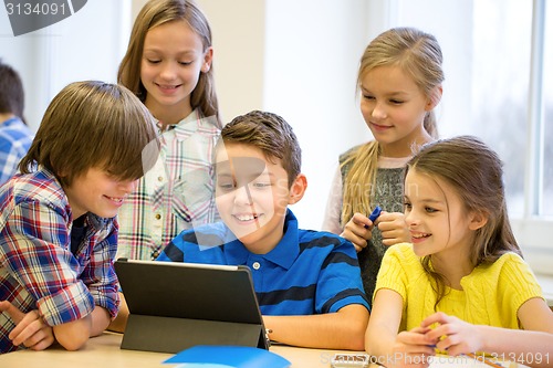 Image of group of school kids with tablet pc in classroom