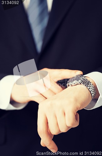 Image of man looking at wristwatch