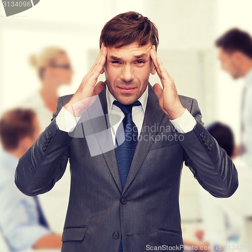 Image of stressed buisnessman or teacher having headache