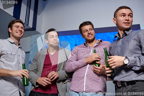 Image of group of male friends with beer in nightclub