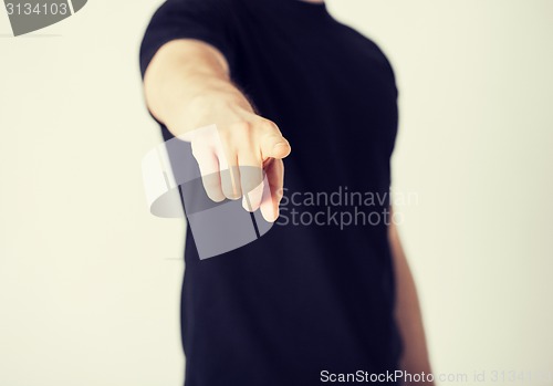 Image of man pointing his finger at you