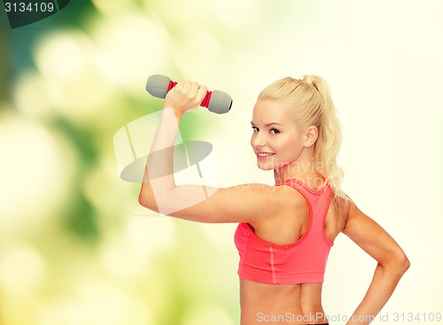 Image of young sporty woman with light dumbbell