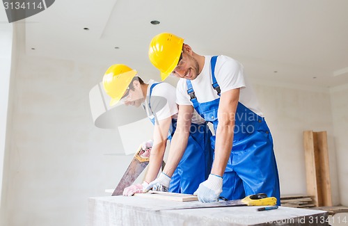 Image of group of builders with tools indoors