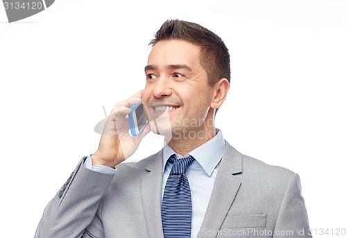 Image of happy businessman calling on smartphone