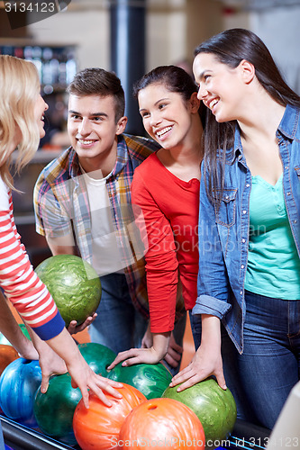 Image of happy friends in bowling club