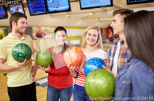 Image of happy friends in bowling club