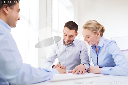 Image of smiling business people meeting in office