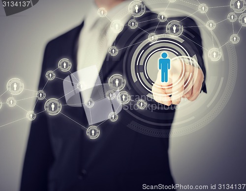 Image of businessman pressing button with contact