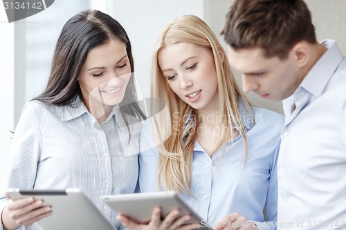 Image of business team working with tablet pcs in office