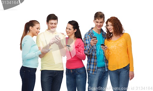 Image of group of smiling teenagers with smartphones