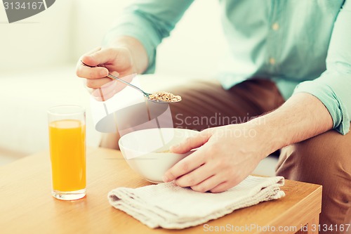 Image of close up of man eating breakfast at home