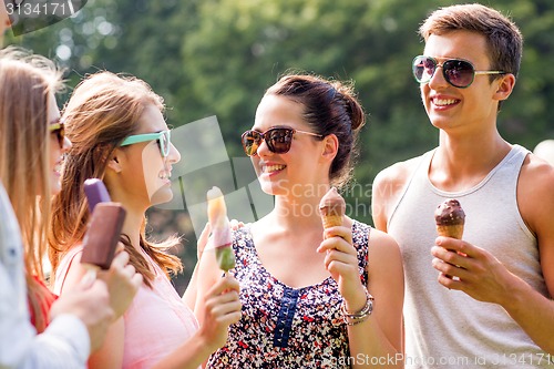 Image of group of smiling friends with ice cream outdoors