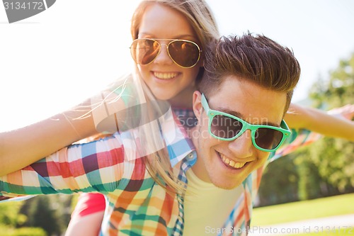 Image of smiling couple having fun in park